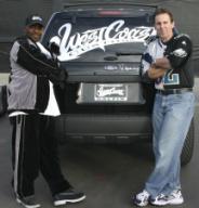 Craig Steichen, VP of Marketing for Super Concepts, and Q of West Coast Customs (MTV's "Pimp My Ride") stand next to a customized 2005 Ford Escape SUV. (Photo from Ford; February 2005)