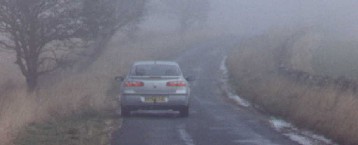 While this fog was not thick enough to show the full benefits of the rear fog lights (right), it does not take much imagination to realise the major benefits when visibility gets worse. These photographs -- copyright Eddie Wren, 2005 -- are from the DSA test drive of a Renault Laguna in England. (The ordinary rear lights are on in both photographs.)